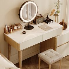 a desk with a mirror, stool and laptop on it