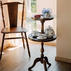 two trays with tea cups and plates on them