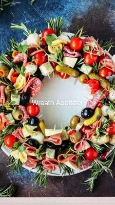 a wreath made out of different types of meats and vegetables on a white plate