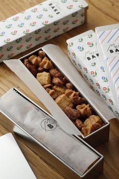 some kind of food in a box on a table with other boxes and papers around it