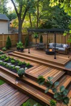 a wooden deck with steps leading up to a fire pit and seating area in the middle