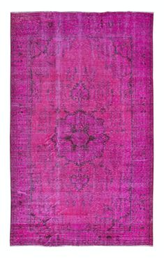 a pink rug with an ornate design on the middle and bottom, in different colors