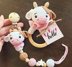 a crocheted elephant keychain is being held by a person's hand