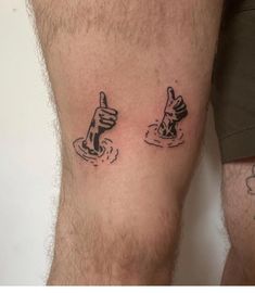 two men with tattoos on their legs giving the thumbs up and down signs in front of them