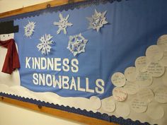 a bulletin board with snowflakes on it and writing underneath the words kindness, snowballs