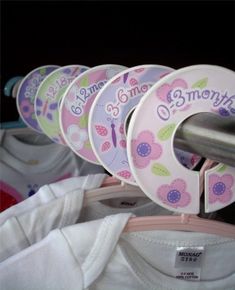 baby clothes are hanging on the rack with name tags