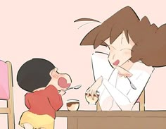 a little boy sitting at a table next to a woman eating cake and drinking coffee