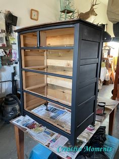 an old dresser is being worked on with wood and metal trimmings to make it stand out from the rest of the room