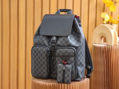 A versatile and stylish business bag, the Utility Backpack is made from Damier Graphite canvas, and includes features such as a drawstring, red metallic D-ring, and a rich red textile lining. Inspired by the Trio Backpack from the Fall-Winter 2019-20 collection, it has two large side pockets and adjustable shoulder straps for ultra-comfortable wear. Detailed Features 33 x 41 x 16 cm (Length x height x width ) Damier Graphite coated canvas Cowhide leather trim Textile lining Matte-black and red h Utility Backpack, Red Textiles, Business Bag, Vuitton Bag, Sierra Leone, Exclusive Bag, D Ring, New Bag, Look Fashion