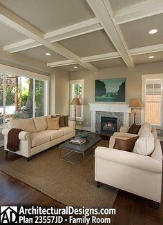 a living room filled with furniture and a fire place in the middle of a room