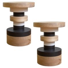 two wooden stools with black and white tops