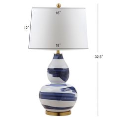 a blue and white striped lamp with a large shade on the top, next to a smaller one