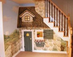 a doll house with a thatched roof and stairs