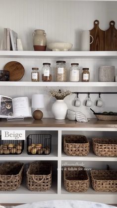 an open book shelf filled with lots of books and other items on top of it