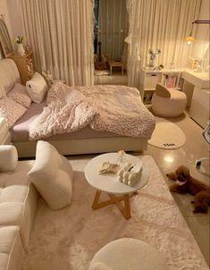 a bedroom with white furniture and lots of pillows on the bed, along with two teddy bears