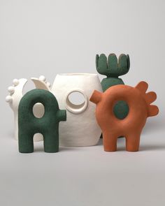 three ceramic animals are standing next to each other