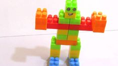 a toy made out of legos is on the floor with it's arms and legs extended