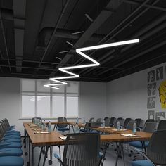 an empty conference room with blue chairs and wooden tables