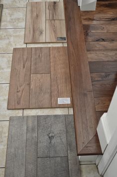 wood flooring samples are laid out on the floor next to each other in a kitchen