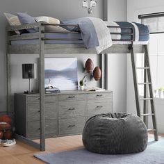 a bedroom with bunk beds and a large bean bag chair on the floor next to it