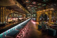 the interior of a fancy bar with colorful lighting