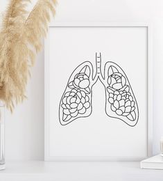 a black and white drawing of the lungs on a wall next to a vase with flowers