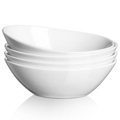 four white bowls stacked on top of each other