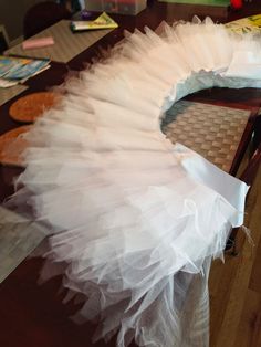 a white tulle skirt sitting on top of a table next to a cookie box