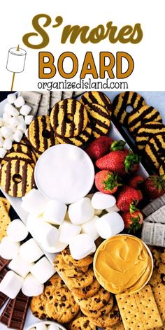 a platter filled with s'mores, marshmallows and strawberries