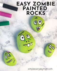 three rocks with faces painted on them and the words easy zombie painted rocks above it