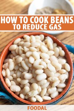 a bowl filled with beans sitting on top of a wooden table