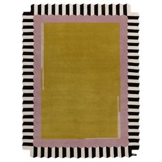 a yellow rug with black and white stripes on the bottom, in front of a white background