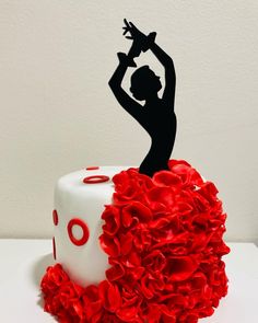 a cake decorated with red ruffles and a silhouette of a woman holding a cupcake