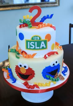 a birthday cake with sesame street characters on it