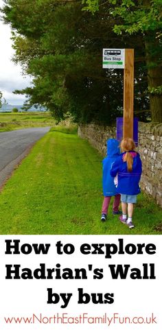 two children carrying a wooden sign on the side of a road with text overlaying how to explore hadrian's wall by bus