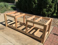 a wooden bench sitting on top of a sidewalk