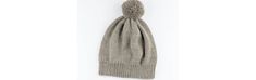 a gray knitted hat hanging from the side on a white wall, with a pom - pom at the top