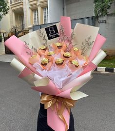 a woman holding a bouquet of flowers in front of a building