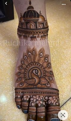 the foot is decorated with henna and peacocks