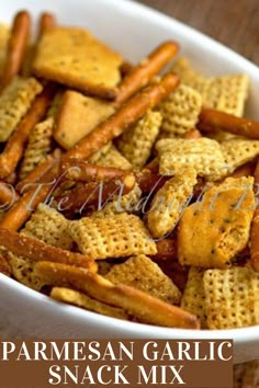 parmesan garlic snack mix in a white bowl on a wooden table with text overlay