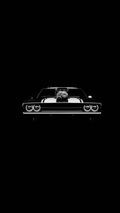 a black and white photo of a car in the dark