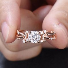 a person holding a diamond ring in their hand