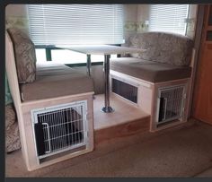 the inside of a recreational vehicle with two beds and a table in front of it