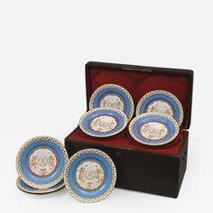 four blue and white plates in a box