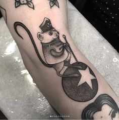 a black and white photo of a mouse on the arm with stars around it,