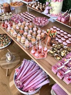 a table filled with lots of cupcakes and desserts