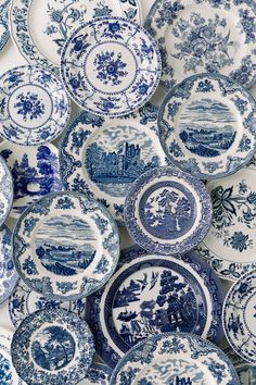 many blue and white plates are stacked on top of each other in the same pattern