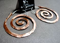 "These swirl hoops are hand pound, shaped and polished. Hand made ear wires are sterling silver. Great for every day. The texture and hand forged quality catches the light and give these simple earrings dimension. High quality craftsmanship, but light weight. Available in solid copper, bronze or sterling silver. Ancient spiral meaning: Evolution, Life, Consciousness, Creation Size: Medium 1 7/8\" H x 1 5/8 \" W Finish: Satin finish is a matte brushed finish. High shine is polished to a brilliant Spiral Meaning, Spiral Goddess, Spiral Jewelry, Hammered Jewelry, Metalsmithing Jewelry, Charm Holder, Beachglass Jewelry, Swirl Earrings, Spiral Earrings