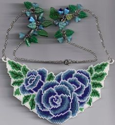 two pieces of beaded jewelry with blue roses on them and green leaves hanging from chains