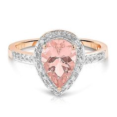 a pink diamond ring with white diamonds on the band and an oval shaped stone in the center